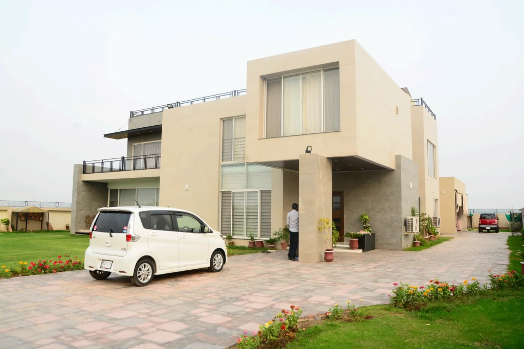 Modern 5 Kanal house design in Gulberg Greens featuring cubic architectural volumes and stone cladding by Babar Malik Architects.