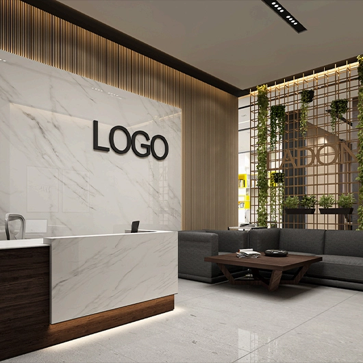 Modern office reception with marble desk and green biophilic partition screen.