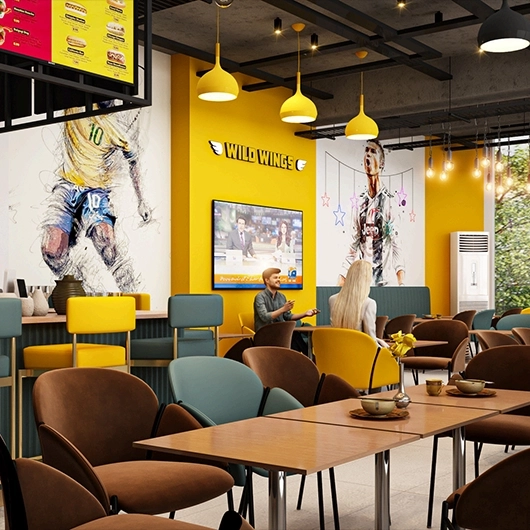 Main counter and branding area of Wild Wings eatery featuring yellow accents and sports murals.